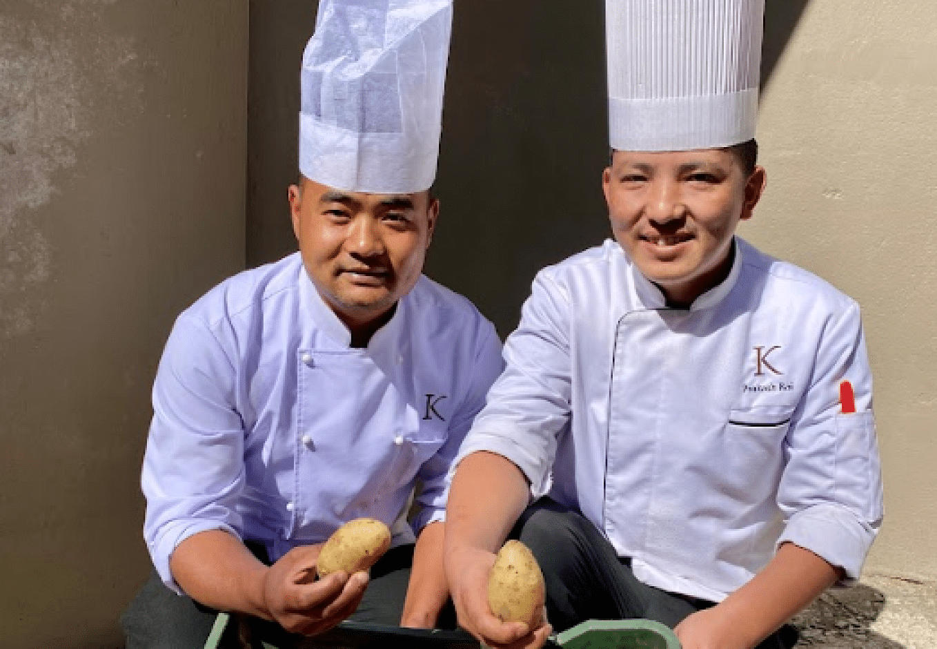 A picture of two chefs holding a potato each  | Kavya Resort and Spa, Nagarkot