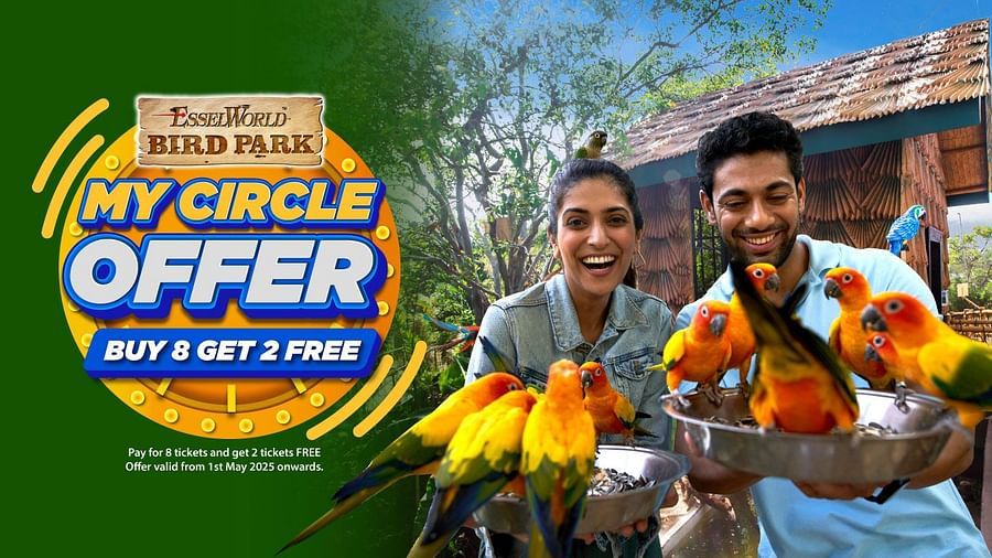 Group of smiling visitors interacting with colorful birds at a bird park under a promotional offer banner