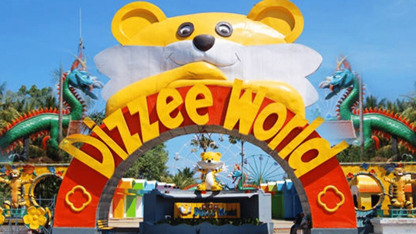 The colourful and playful entrance to Dizzee World amusement park, featuring a large cartoon bear