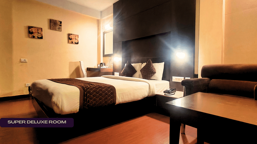 SUPER DELUXE SUPER DELUXE ROOM with cosy bed and table beside itROOM (4)