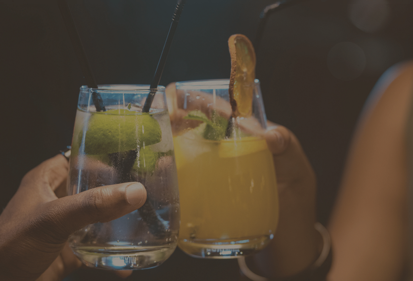Two people clinging their beverage glasses together