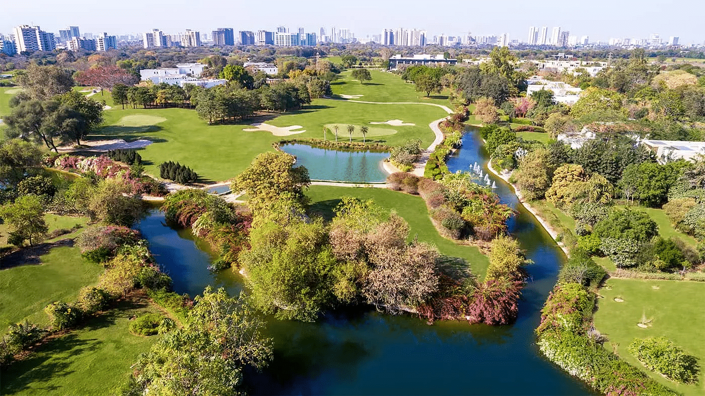 Aerial view of a golf course and surrounding trees at Karma Lakelands.
