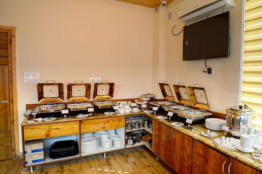 Buffet arrangement alongside a wall with a TV - Clarks Inn Suites, Manali