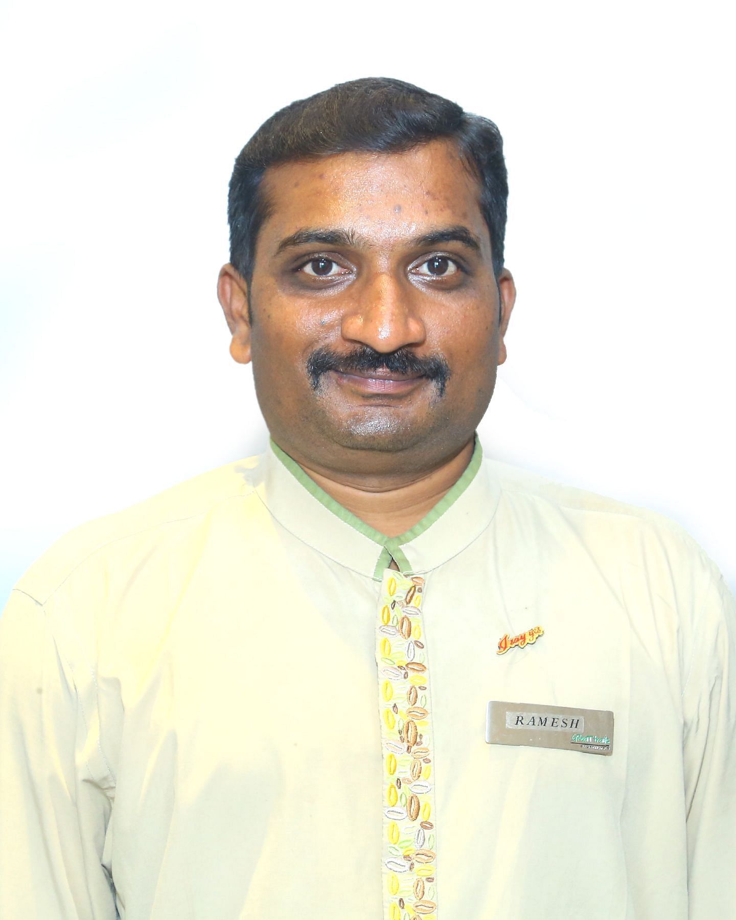 A close up shot of a staff member of Great Trails Yercaucd by GRT hotels.Mr.Ramesh Front Office