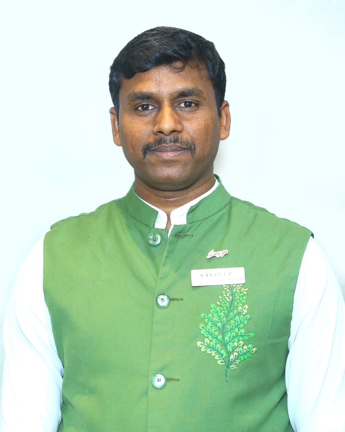 A close up shot of a staff member of Great Trails Yercaucd by GRT hotels.