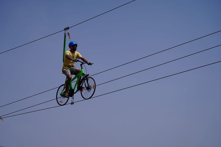 A person rope cycling with intact safety measures at GK Hill View Resort.