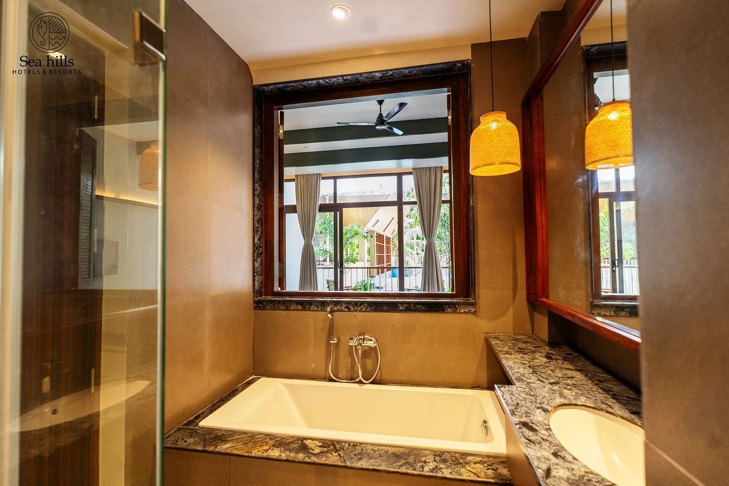 Close-up of a well-designed bathtub with a marble surround and ambient lighting, ideal for relaxation - Sea Hills Resort, Swaraj Dweep (Havelock)