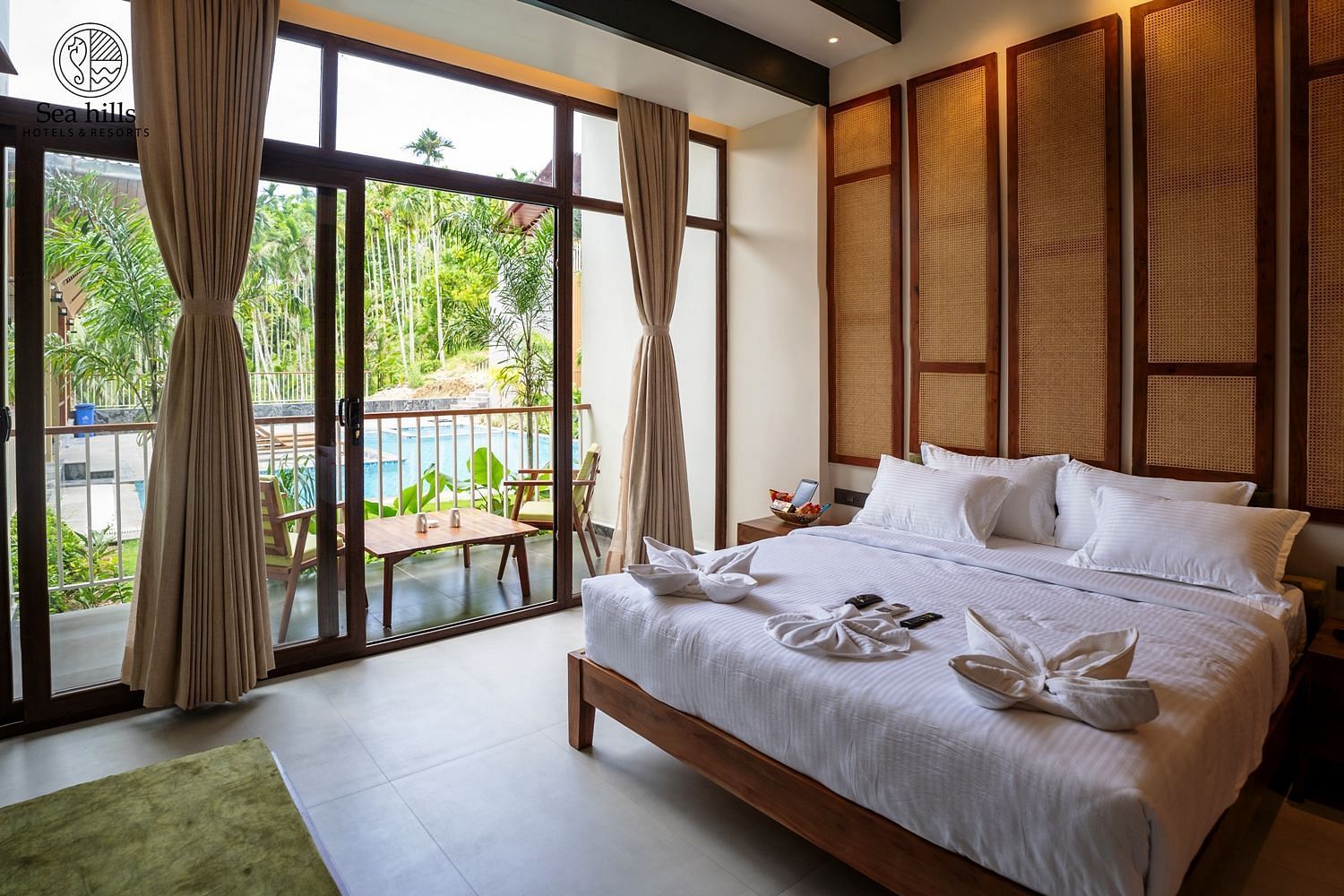 Well-lit bedroom featuring ample natural light, a comfortable bed, and scenic views of greenery outside - Sea Hills Resort, Swaraj Dweep (Havelock)