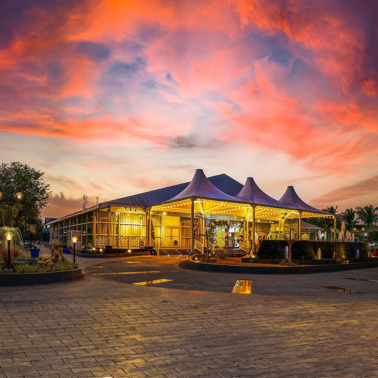 the exterior of the banquet hall in Muthukadu during evening