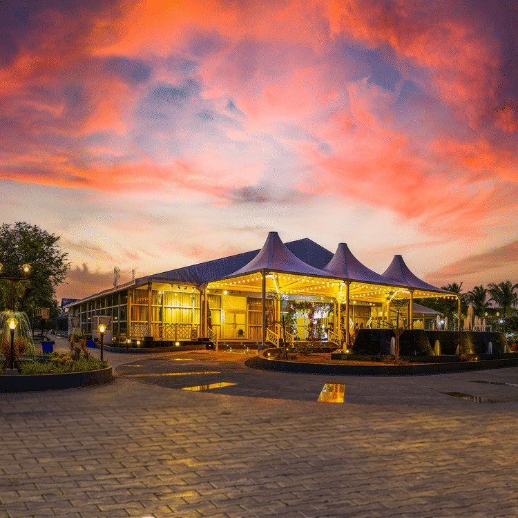 the exterior of the banquet hall in Muthukadu during evening