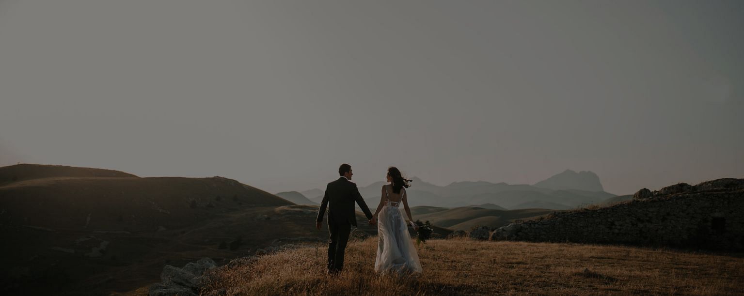 A couple walking in a field - Narrow Gauge Inn - A Serenite Hotel Near Fish Camp.