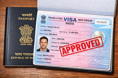 An open visa next to a closed Indian passport with the stamp Approved marked