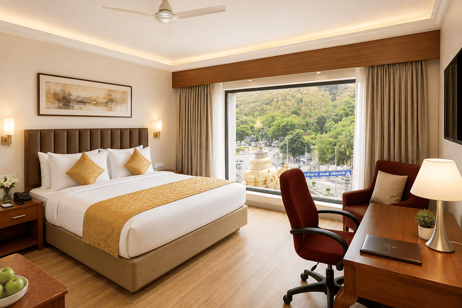 Superior Room at Raj Park Hotel in Tirupati featuring a plush bed facing the TV on the wall with a work desk below it next to a large floor-to-ceiling window