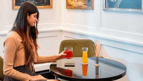 A girl enjoying her drink in the corner of the dining area at Jehan Numa Palace
