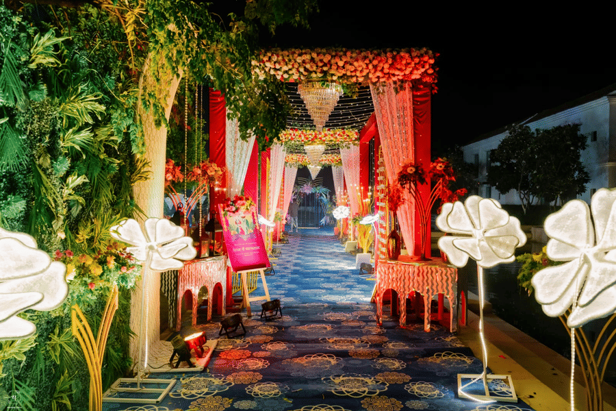 Decorated event entrance at Marasa Sarovar Premiere, Bodhgaya featuring illuminated floral decor, draped fabrics, and a patterned walkway