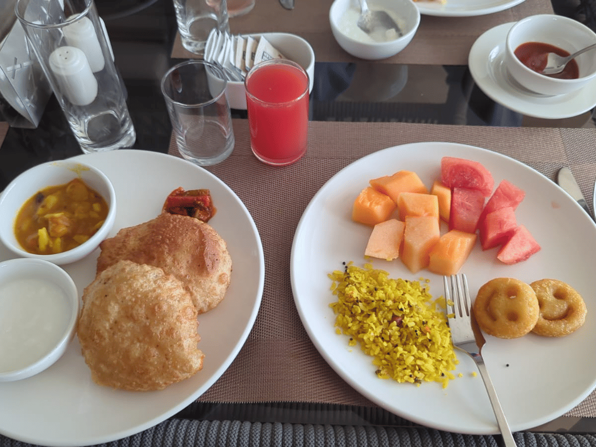 Puri, sabzi and seasonal fruit served at a table at Signum Resort, Bandhavgarh