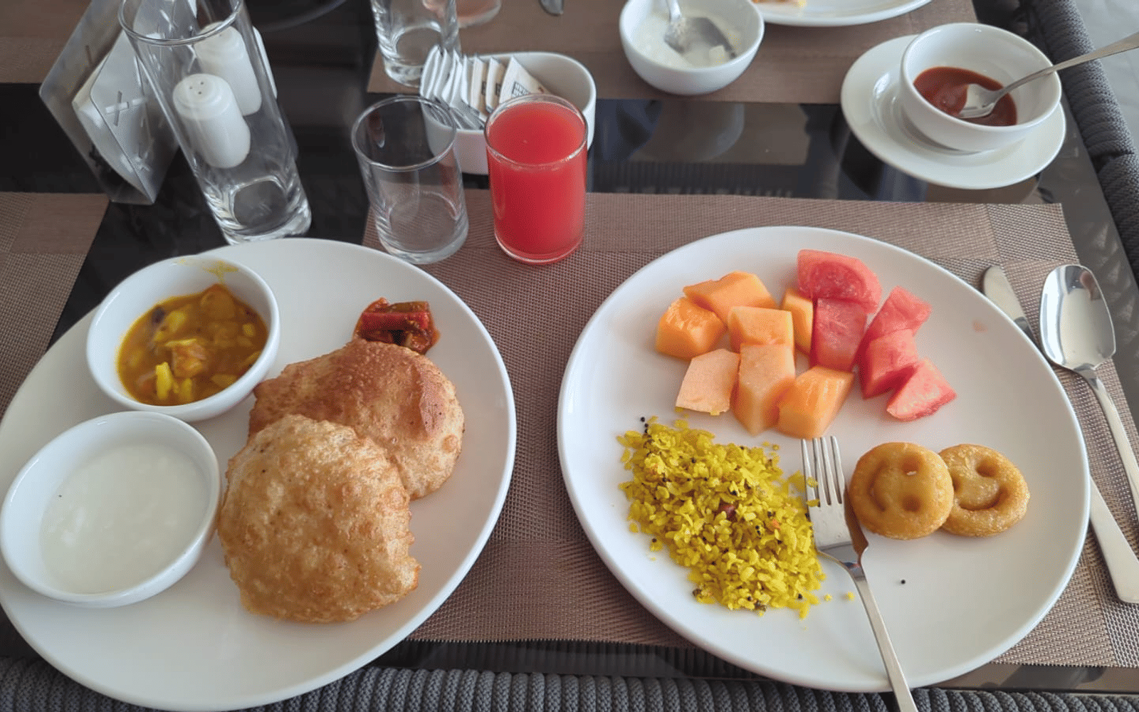Puri, sabzi and seasonal fruit served at a table at Signum Resort, Bandhavgarh