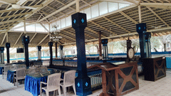 Spacious open-air dining setup with blue décor and seating at Fantasy Golf Resort.