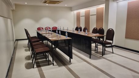 A conference room with a long table and chairs, set up for a formal meeting or presentation at Shilton Dee Cee.