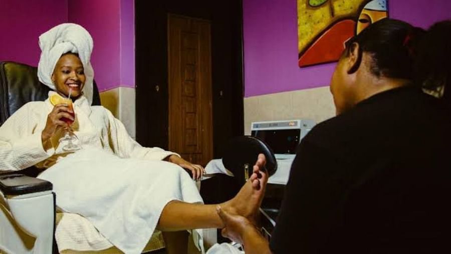 Guest in robe enjoying a relaxing pedicure treatment in the spa lounge at The Boma Nairobi.