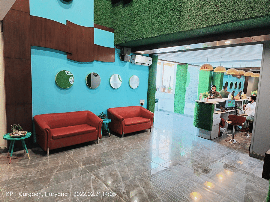 A modern waiting area with sofas and a decorated wall.
