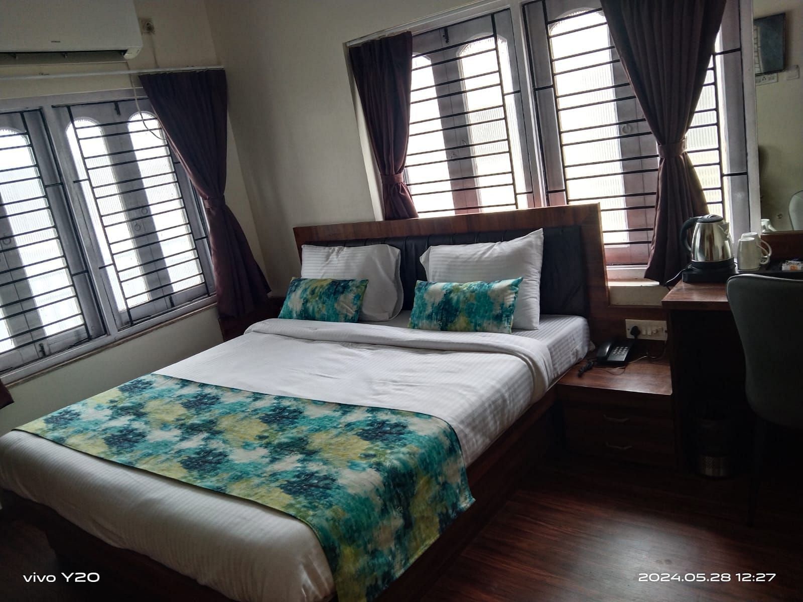 side view of the double bed inside Premium Room without Balcony - Ecotel Kolkata
