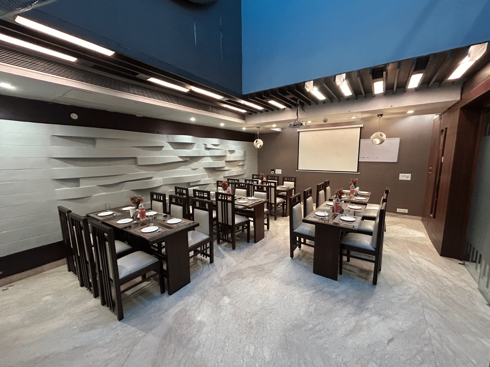 A vibrant restaurant interior with organised seating, sophisticated decor, and ample space for gatherings - Hotel Emerald, Chandigarh