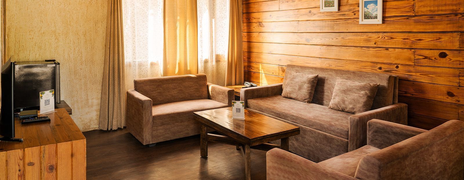A view of a sofa seating around a coffee table in a room at The Sylvan Retreat, Dehradun.