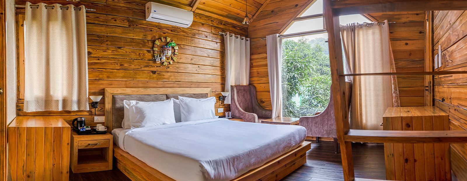 A view of a large bed in a room at The Sylvan Retreat, Dehradun.