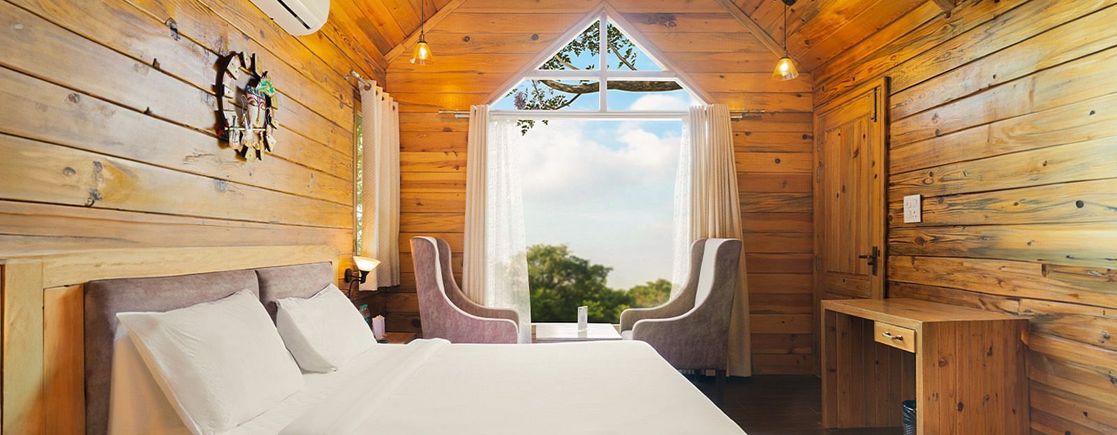 A view of a large bed in a room at The Sylvan Retreat, Dehradun.