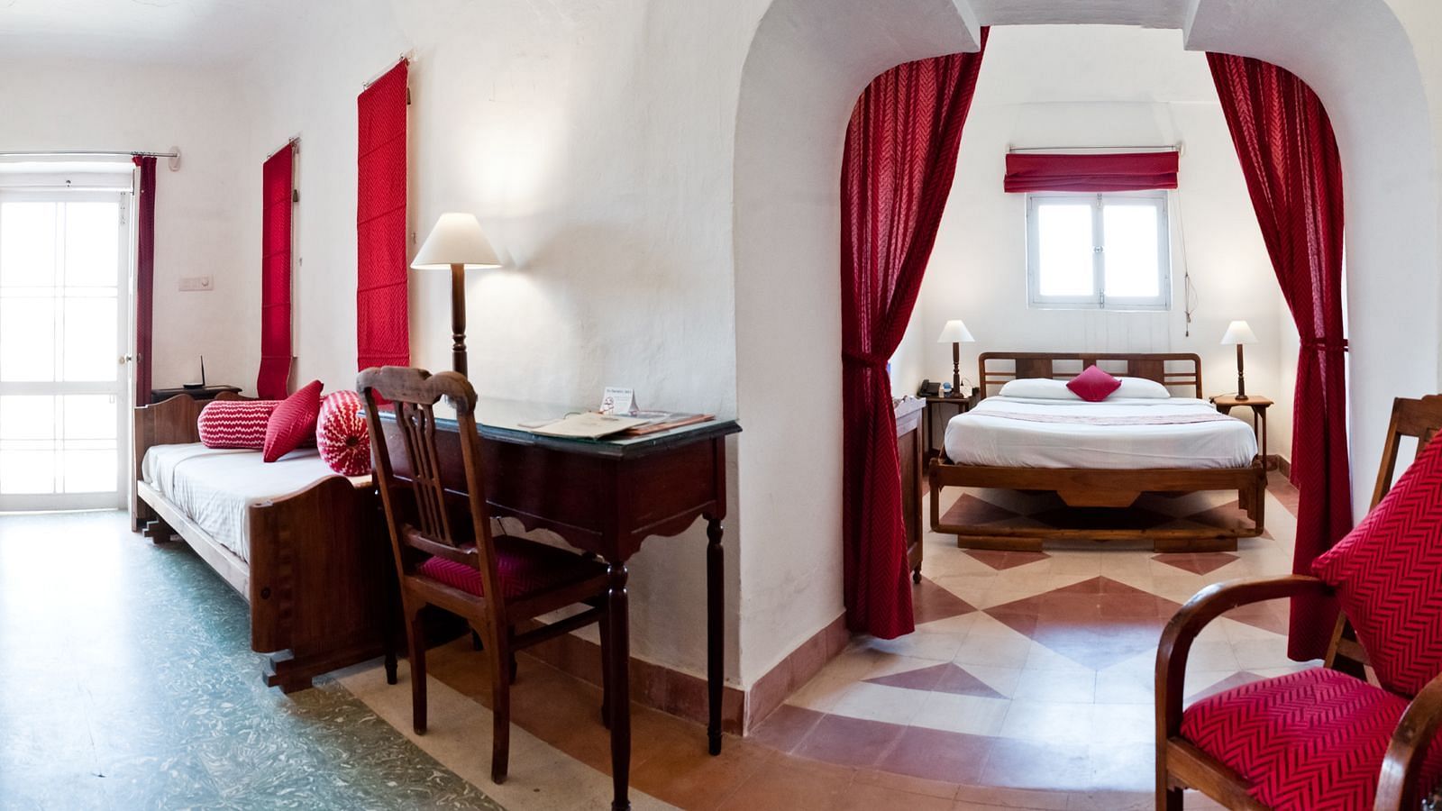 Hill Fort Kesroli 14th Century Alwar - interior view of the Shri Mahal - Village View with a king size bed and red curtains