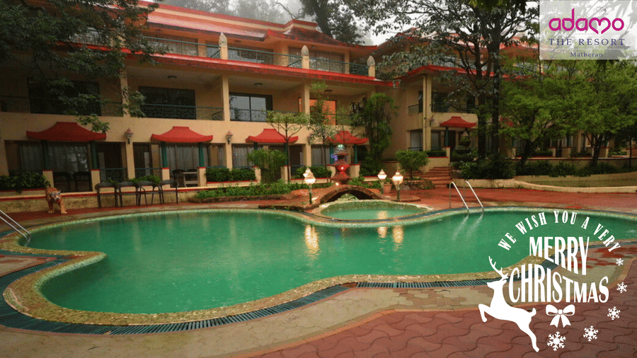 A Christmas celebration poster for the hotel with an image of the pool and hotel building.