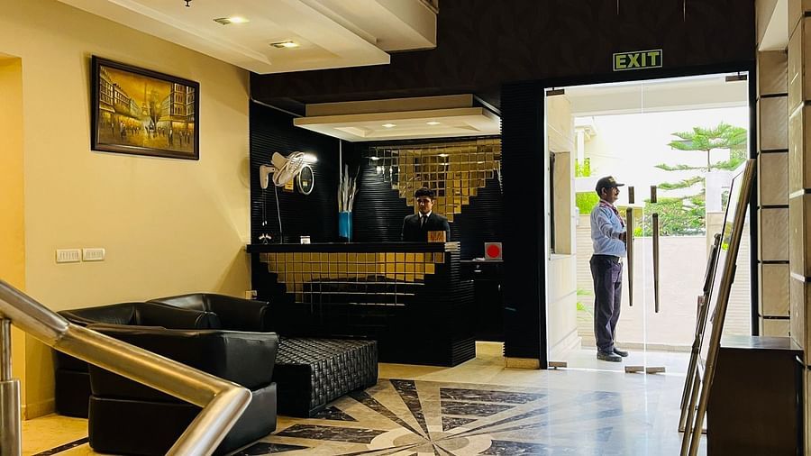 The reception area of a hotel features seating arrangements and a reception counter - Five Elements Hotels