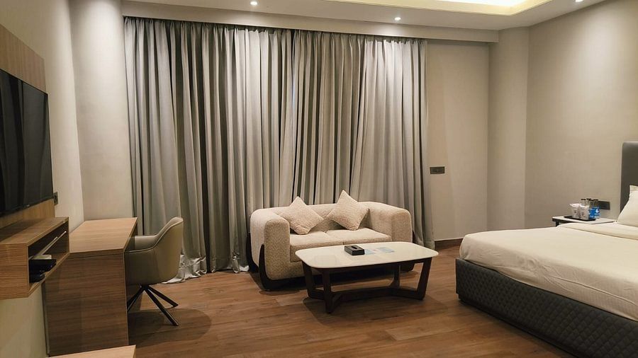 Superior Forest View Room at Silver Sand Sea Princess Beach Resort with double bed, sofa, work desk, flat-screen television, and floor-to-ceiling curtains creating a cosy ambience
