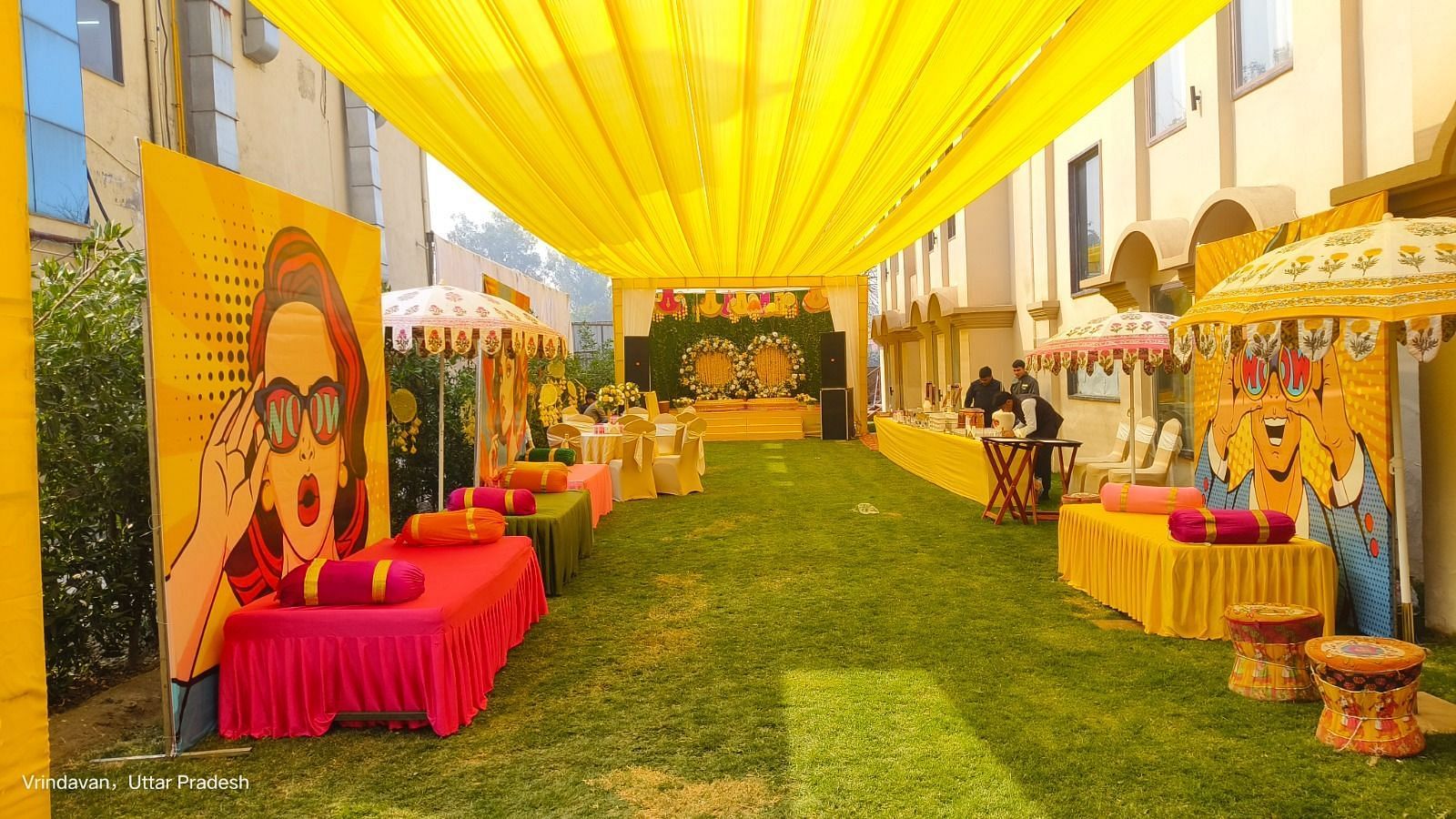Brij Eternity, Vrindava |  A vibrant, open-air setup with bright yellow drapes and festive décor for pre-wedding rituals.