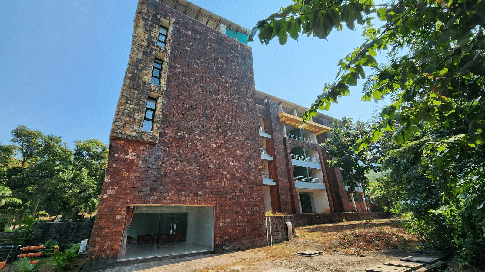 A full view of the facade of the building with trees framing the scene at SeaFort Beach Resort