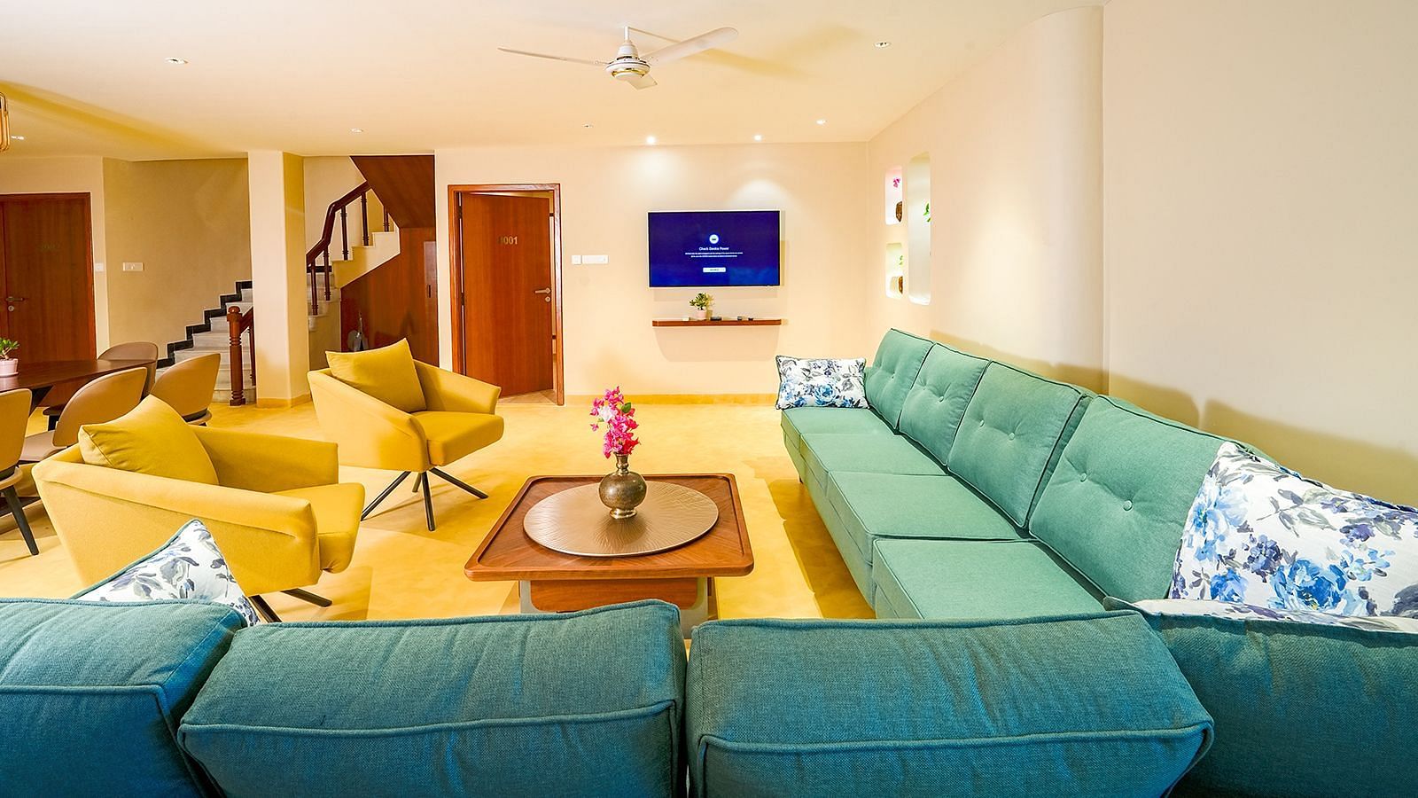 Vasundhara Villa vibrant living room with plush seating, flat-screen TV, and modern interiors at Ramoji Film City.