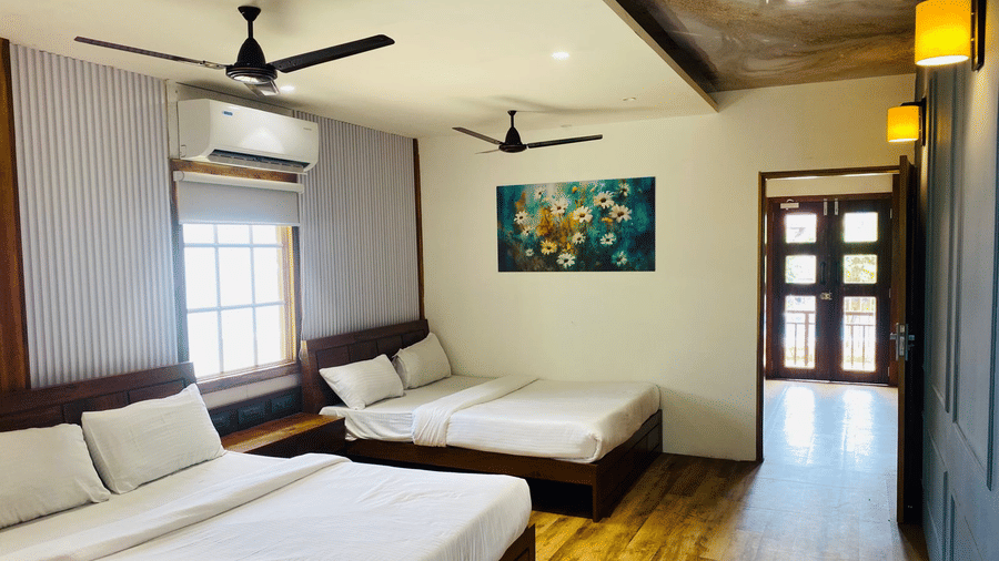 Cosy resort room interior with large windows, artwork, and comfortable bedding - DAN Resorts & Weddings, Palghar