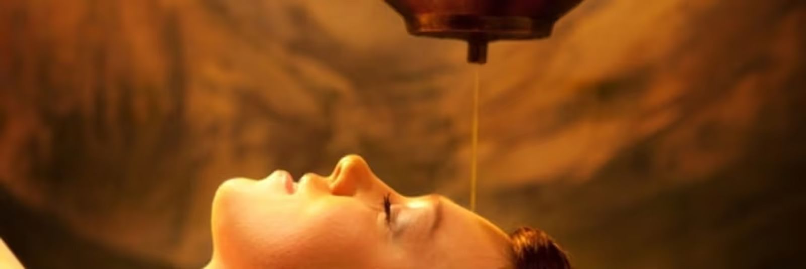 A person getting oil drip therapy at a spa