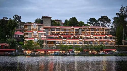 Facade view of The Carlton during day time as seen from across the kodaikanal river.