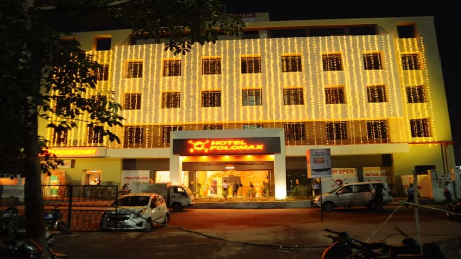 Facade shot of Max Hotel Prayagraj building illuminated at night, with a grand entrance and warm lighting.