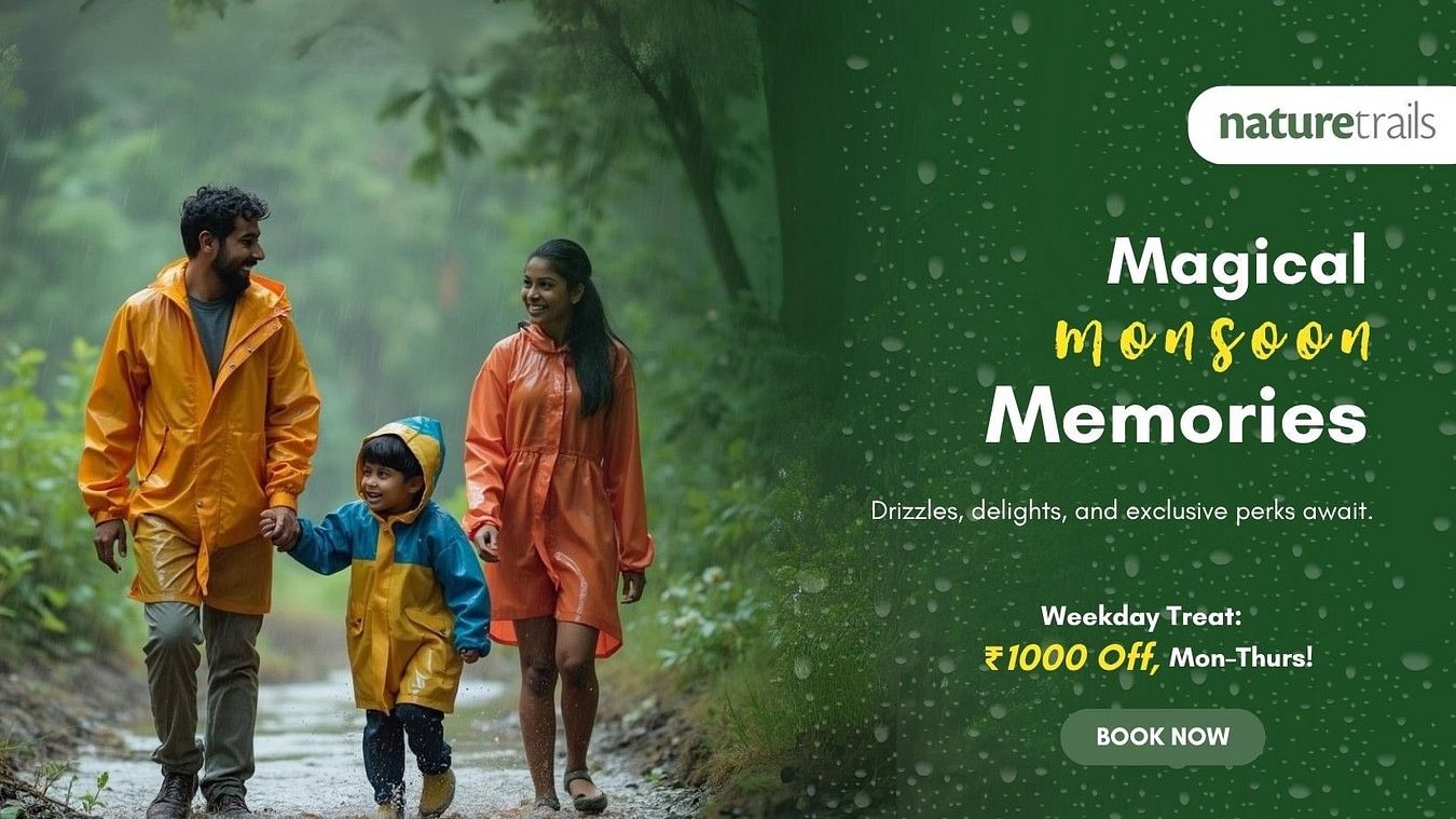  Family in colourful raincoats walking through lush greenery, promoting Magical Monsoon Memories offer at Nature Trails – book now for a rainy retreat.