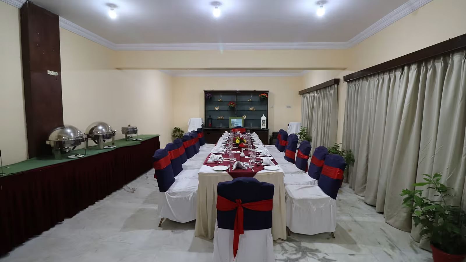 Banquet hall elegantly arranged with tables and chairs, ready for a festive celebration.