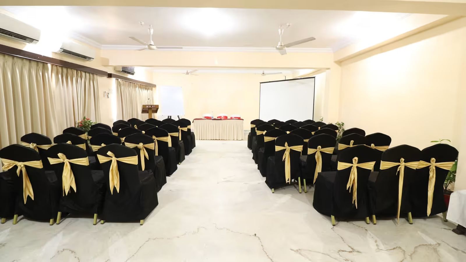 Pelican Event Hall, viewed from the back, features a large conference table at the front, with seating sections arranged on both the left and right sides.