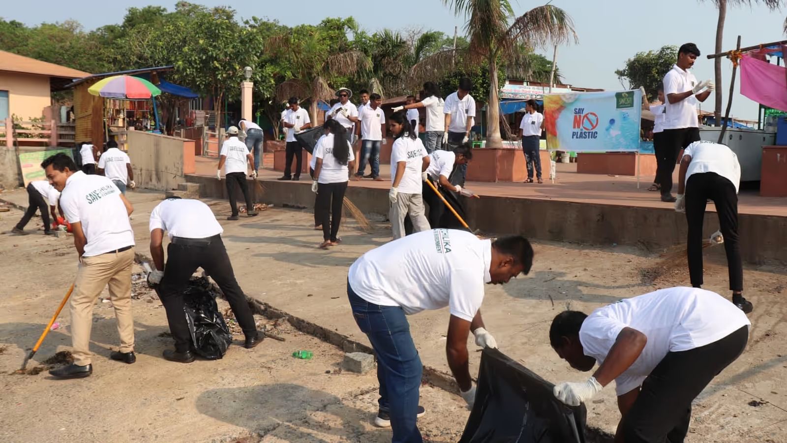 People cleaning up plastic waste on the river bank