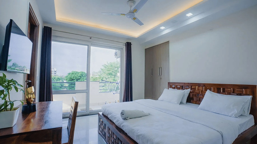 Deluxe Double Room with a double bed and balcony at Lime Tree Hotel, Golf Course Extension Road, Gurgaon