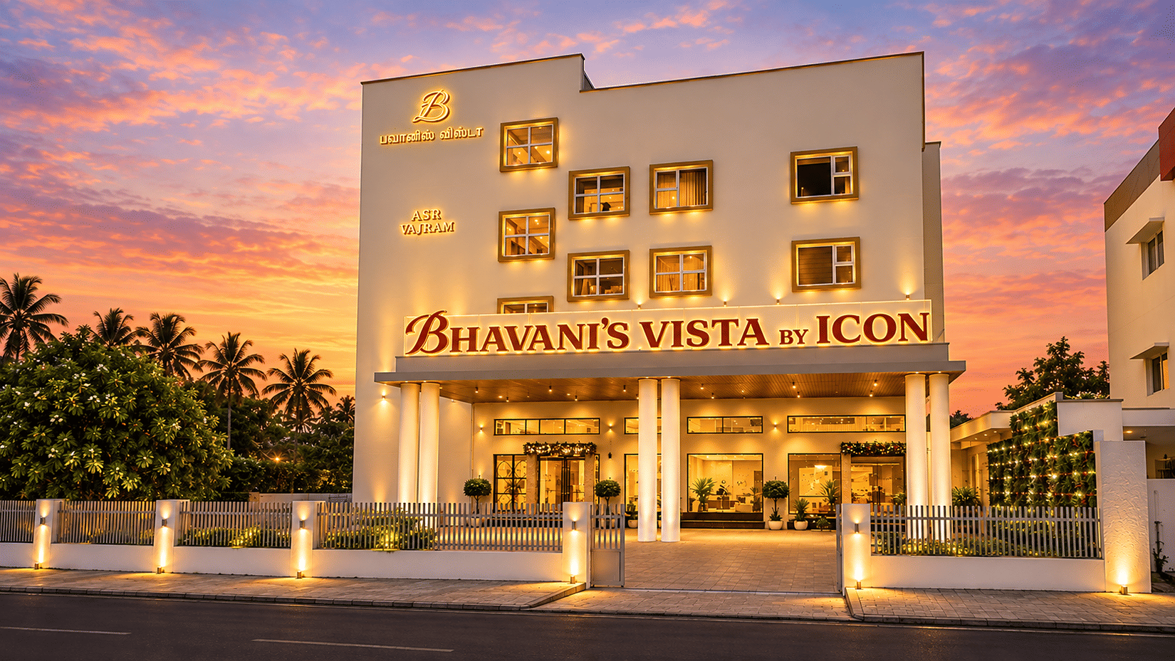 Exterior view of illuminated hotel facade at dusk at Bhavani's Vista By Icon, Hosur.   