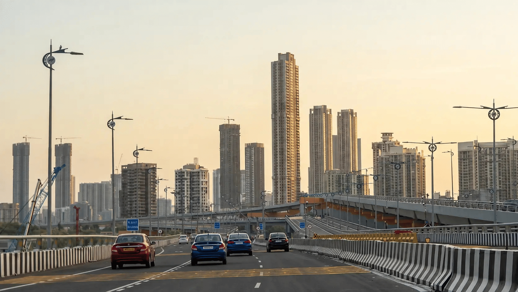 City skyline with high-rise buildings and elevated highway at sunrise