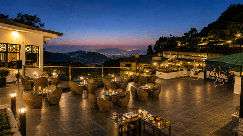 Rooftop dining area with panoramic evening views at Pride Ashiyana Resort Mussoorie.