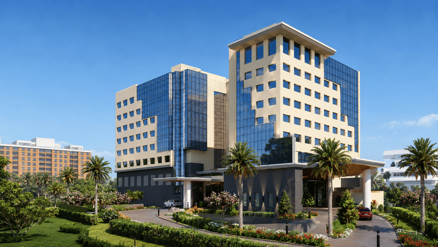 A modern multi-storey hotel building featuring stepped architectural wings, large glass facades, and a paved entrance driveway at Pride Plaza Indore.